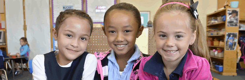 three girls in a classroom